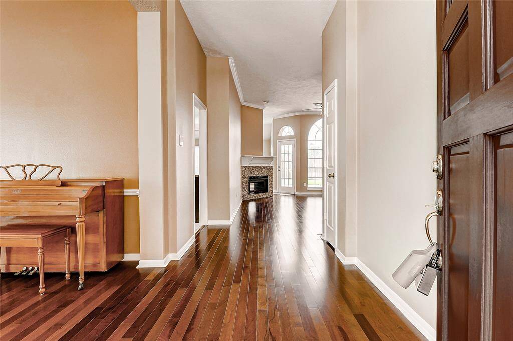 Step through the front door and be greeted by a spacious hallway, an open invitation for friends and family to feel instantly at home. The beautiful engineered wood floors run through most of the home.