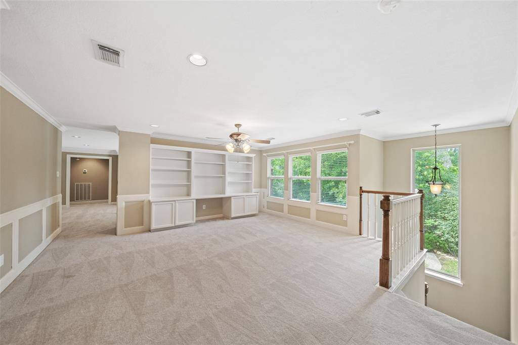 large upstairs family room with built-ins.