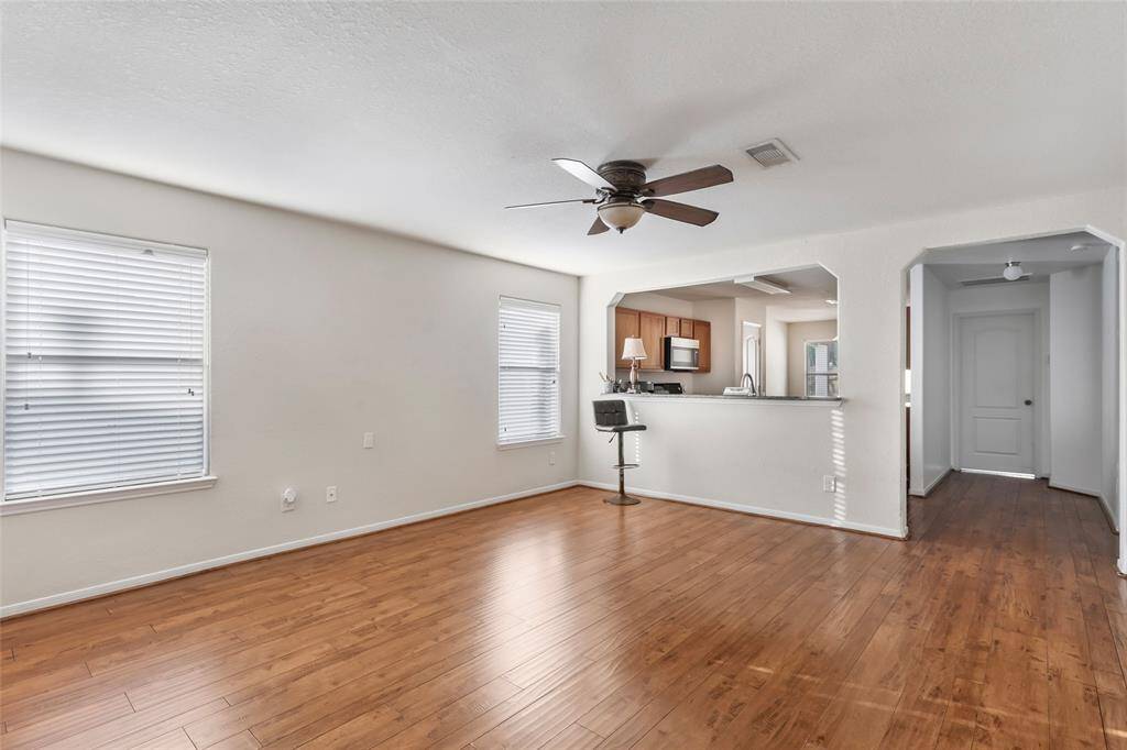 LARGE LIVING SPACE WITH TWO WINDOWS TO ENJOY YOUR PRETTY VIEWS OR FOR KEEPING YOUR EYES ON THE KIDS IN THE POOL.