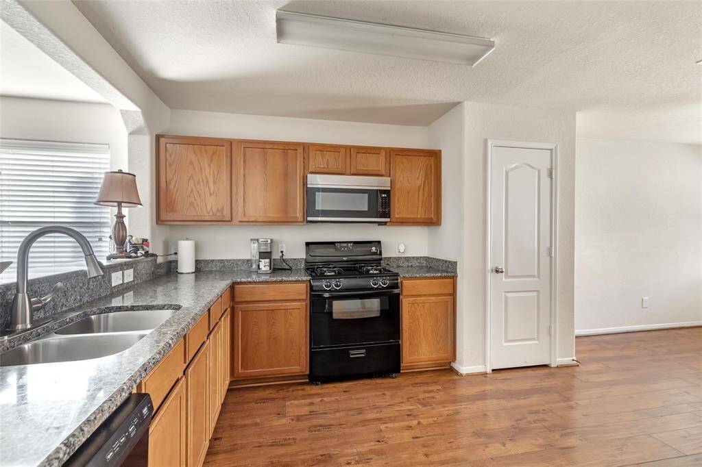 A COOKS DREAM RIGHT HERE!! GAS STOVE, LOADS OF COUNTER SPACE, NEWER MICROWAVE AND DISHWASRER INSTALLED IN 2024. THIS KITCHEN JUST FLOWS, PLENTY OF ROOM IF YOU WANTED TO ADD AN  ISLAND.