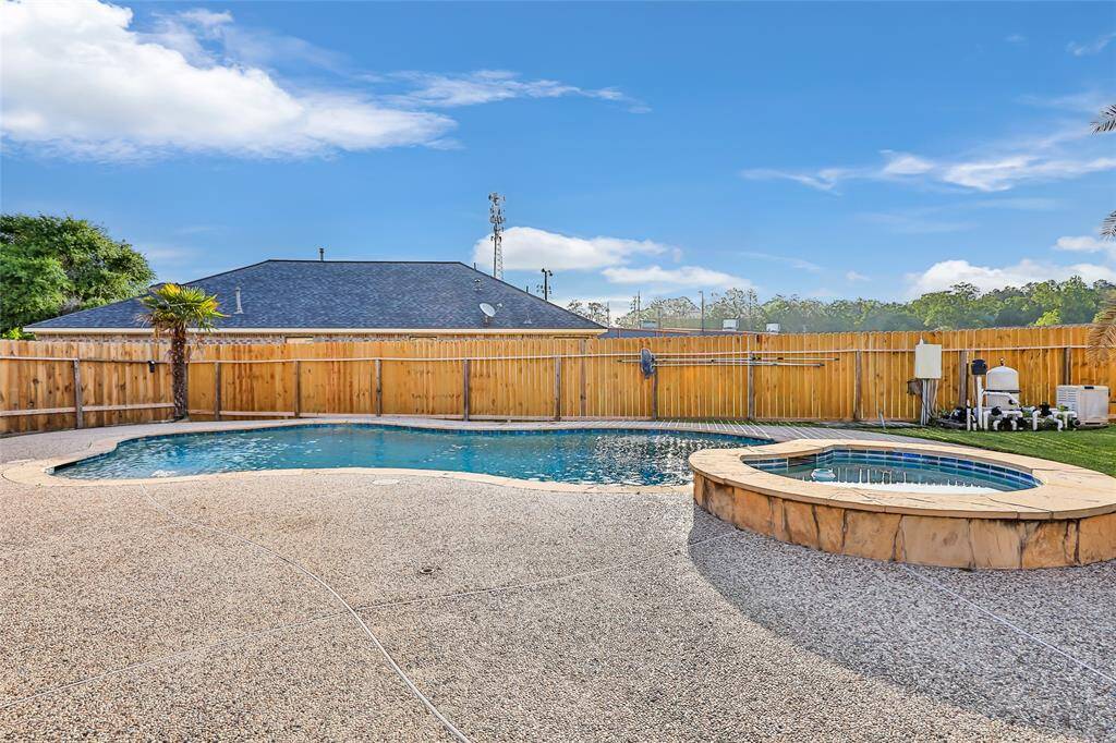HERE IT IS!! THIS IS YOUR HEATED POOL AND SPA WITH TWO TANNING LEDGES, ONE ON EACH SIDE. IT'S LARGER IN PERSON AND HAS THE PRETTIST MOST RELAXING SOOTHING WATER FALL SOUND. SELLER REPLACED THE FENCE IN 2025.