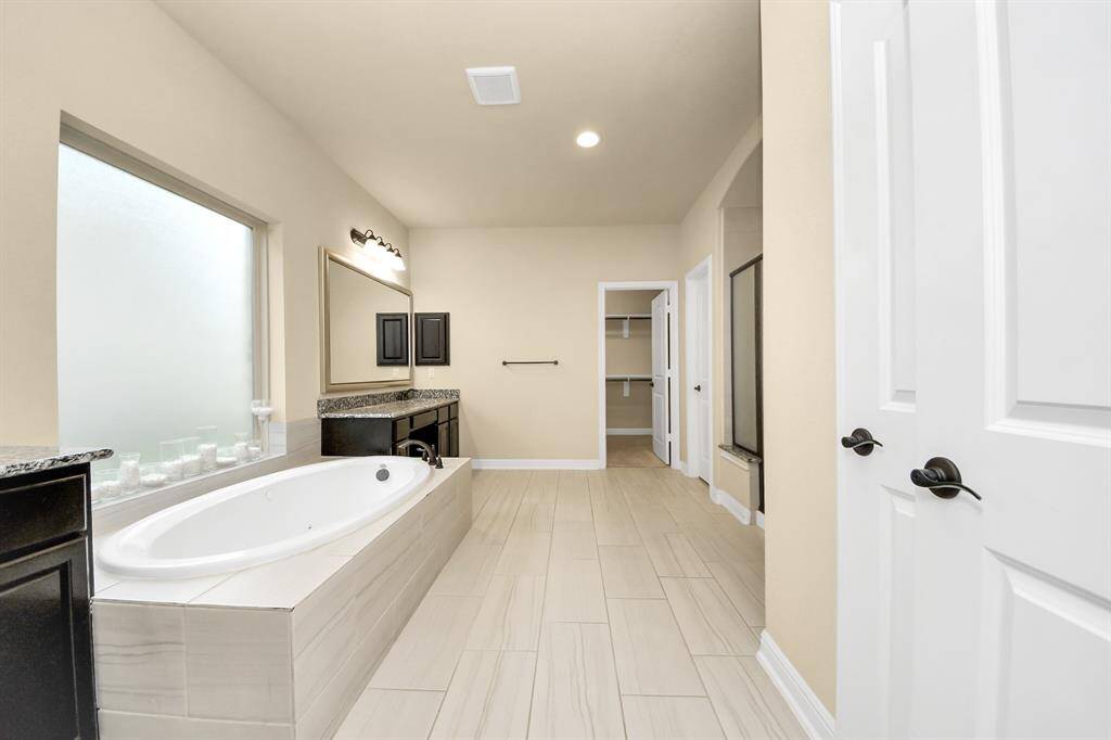 The primary bathroom has a separate shower and soaker tub and dual sinks.