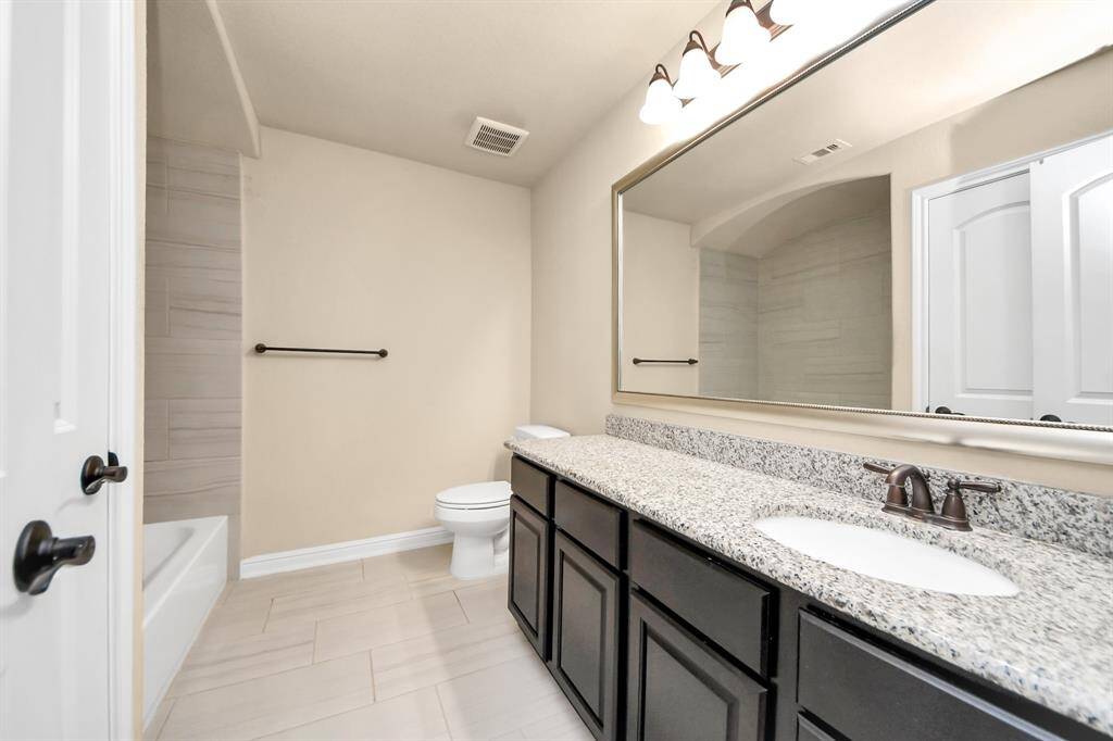 Bathroom #2 features granite countertops, dark cabinetry, a large mirror, and a bathtub/shower combo.