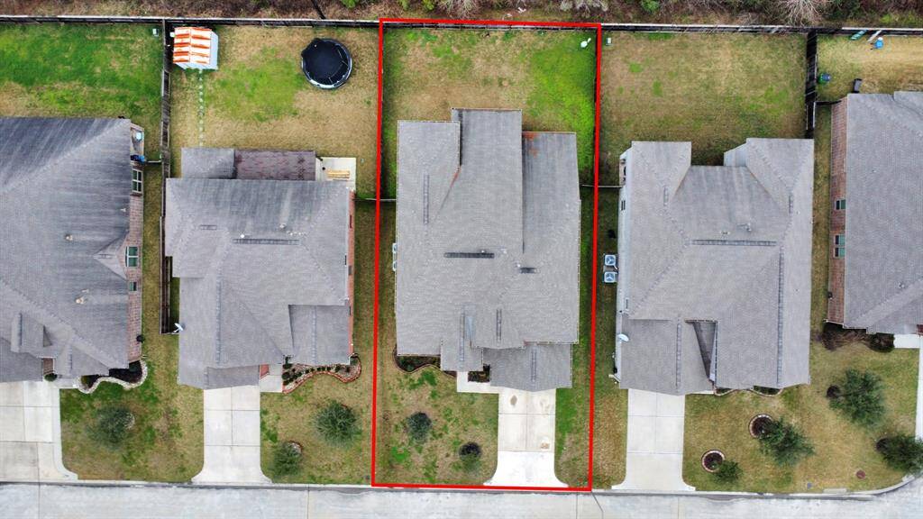This aerial photo to show some of the highlights of 2747 Sica Deer including a modest front yard and backyard, and a driveway.