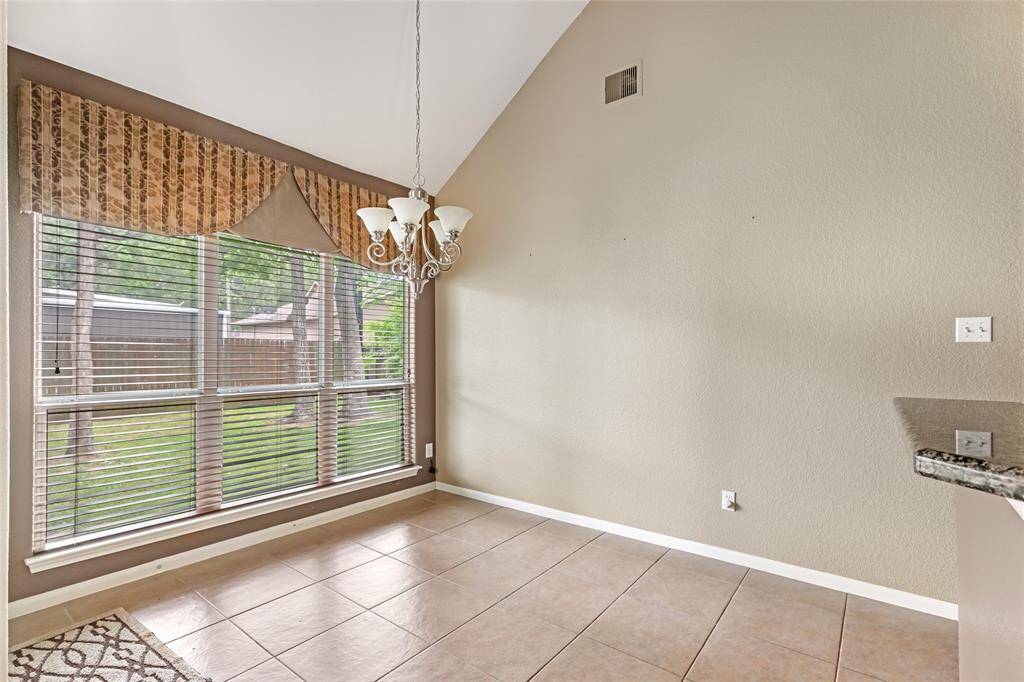 Bright and inviting breakfast nook featuring large windows with scenic views, perfect for morning coffee.