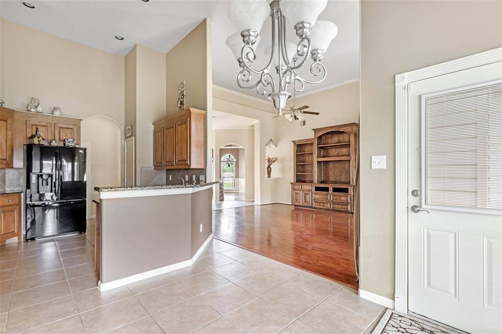 Spacious kitchen with breakfast area, featuring modern appliances and elegant tile flooring, perfect for casual dining and entertaining.