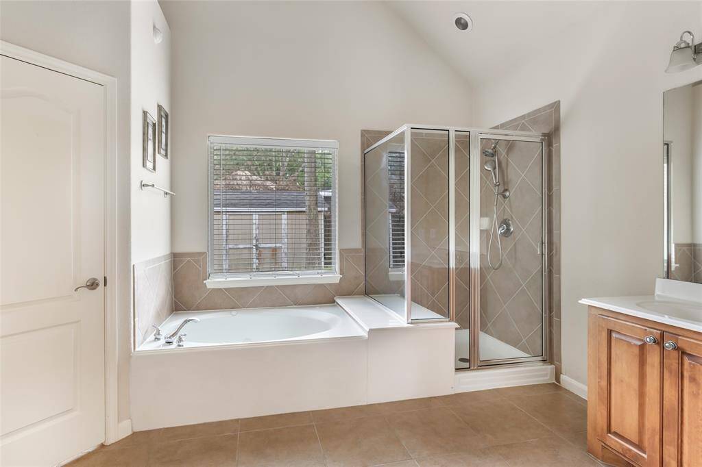 Luxurious bathroom featuring a separate tub and shower for ultimate relaxation and convenience.