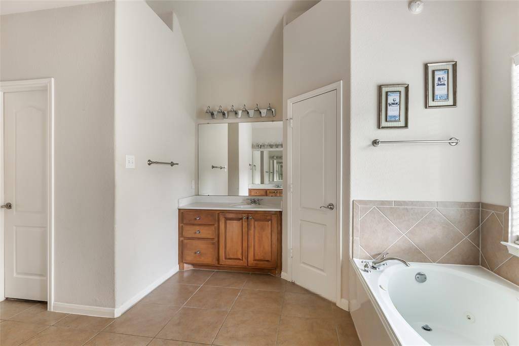 Luxurious bathroom featuring a spacious soaking tub for ultimate relaxation.