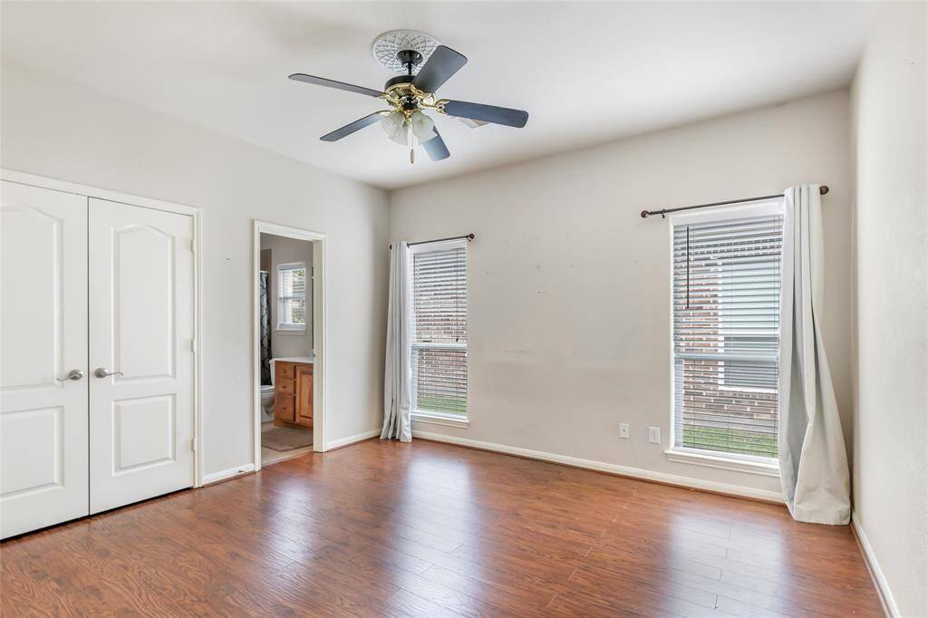 Spacious third bedroom featuring abundant natural light, sleek hardwood floors, and convenient ensuite bathroom access. Perfect for guests or a home office.