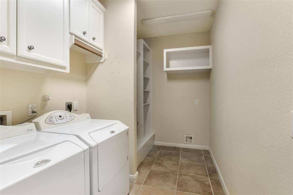 Spacious laundry room offering ample storage and convenience.