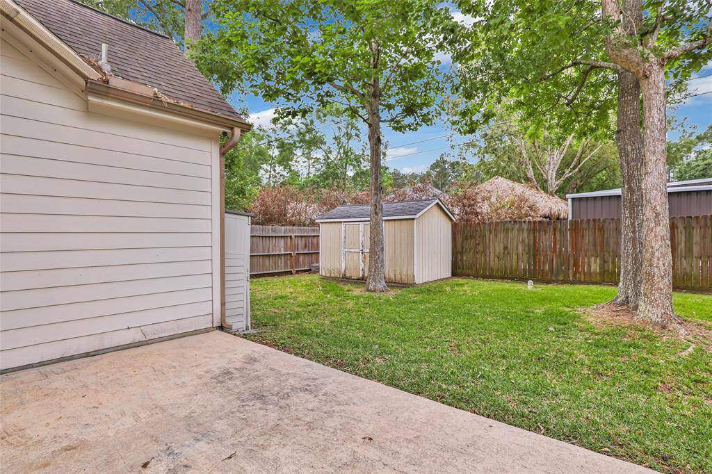 Charming backyard with a practical storage shed, perfect for organizing tools and outdoor equipment.