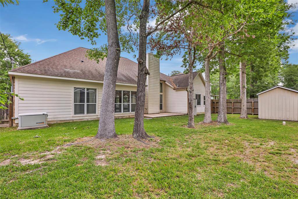 Serene backyard oasis with ample shade from mature trees.