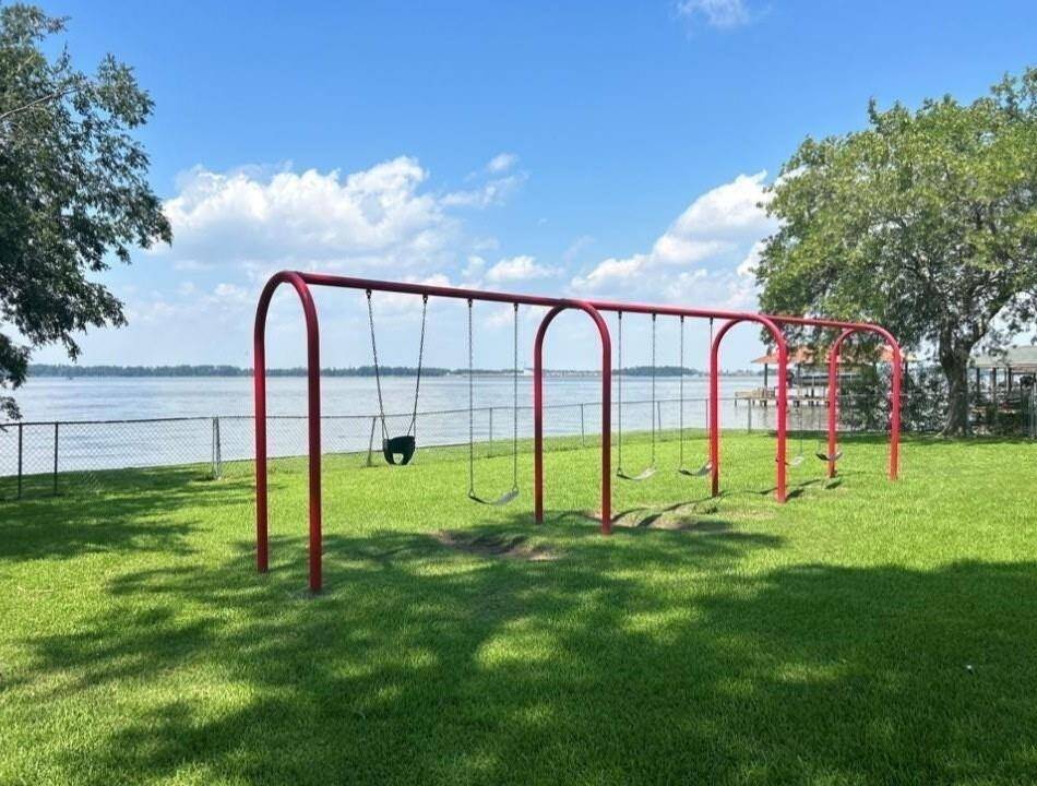 Enjoy serene lakeside views and family fun at this charming park, featuring a vibrant playground and lush green space. Perfect for relaxation and recreation.