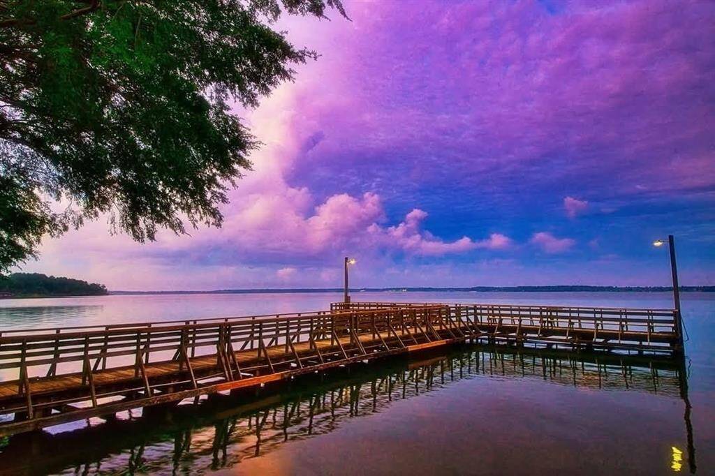 Tranquil fishing pier with stunning sunset views over calm waters, perfect for relaxation and outdoor enjoyment.