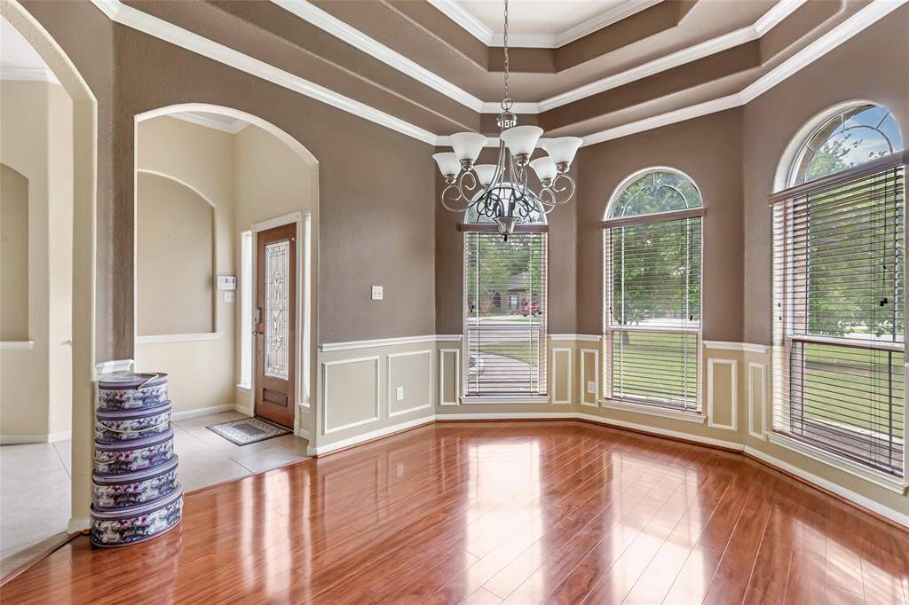 Elegant tray ceiling enhances the versatile dining room or office space.