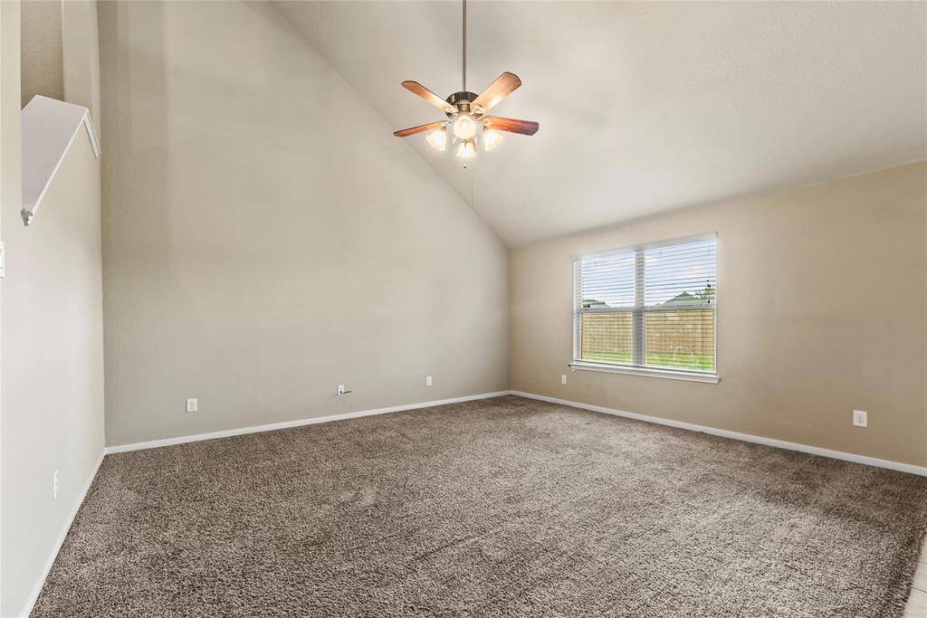 The living room, adjacent to the kitchen and breakfast area, offers a comfortable and inviting space for relaxation and socializing.