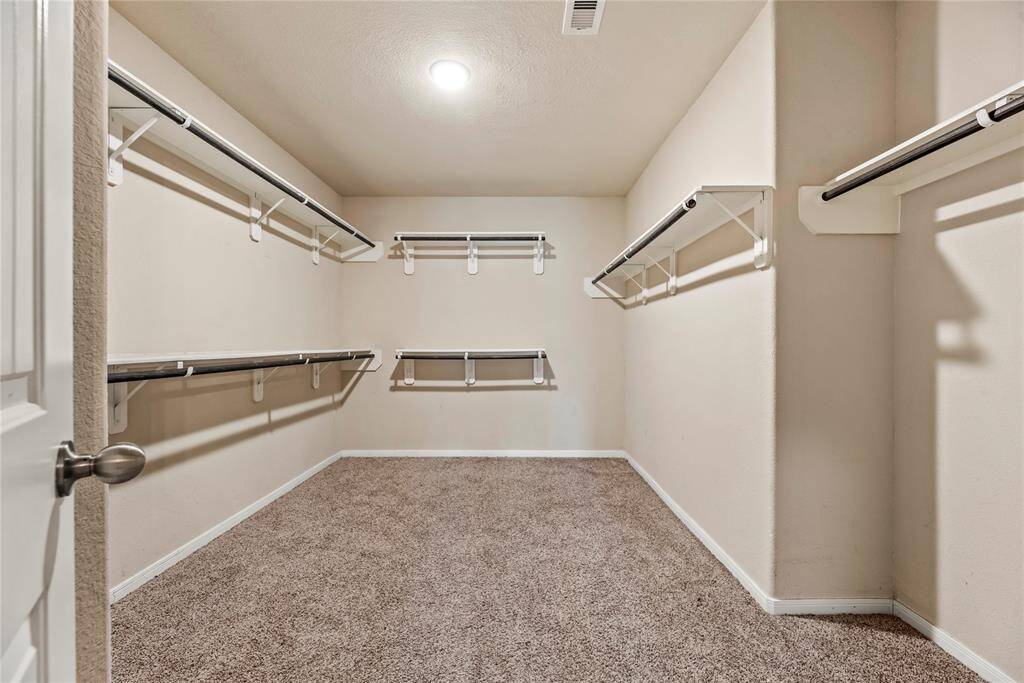 The huge primary closet offers ample space to store all your clothes and keep everything organized.