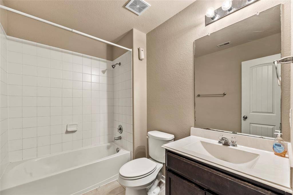 The secondary upstairs bath offers privacy for family and guests.