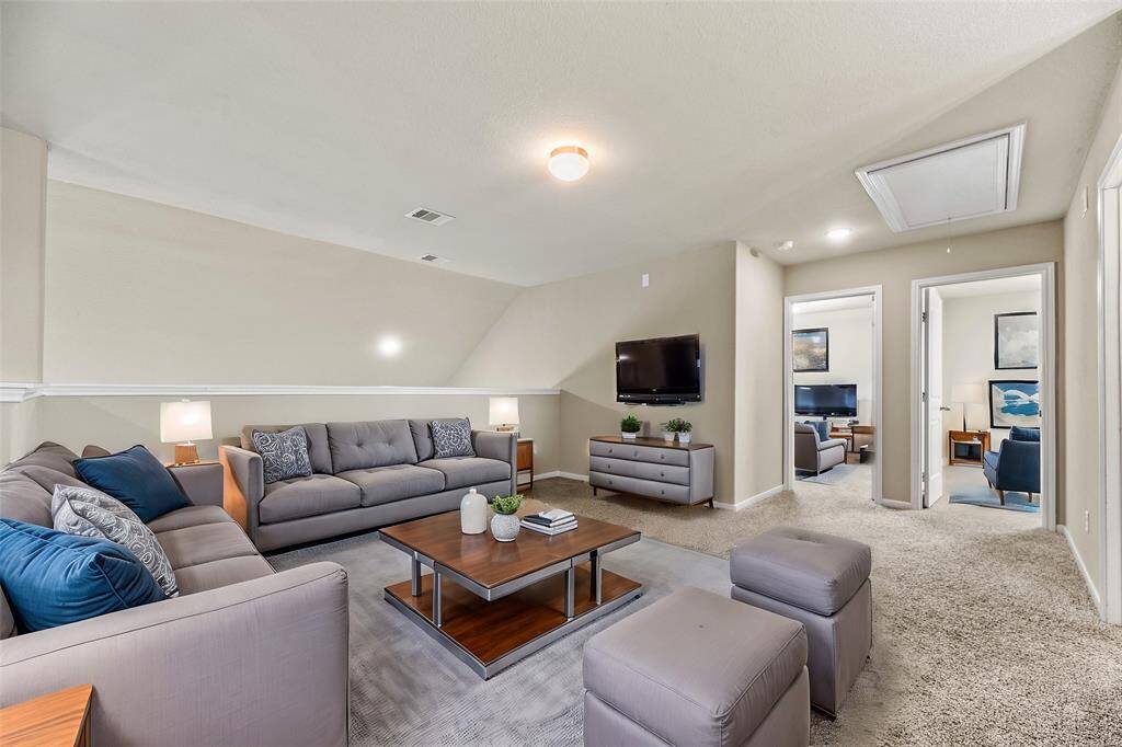 The whole family will love the expansive game room overlooking your living space below.