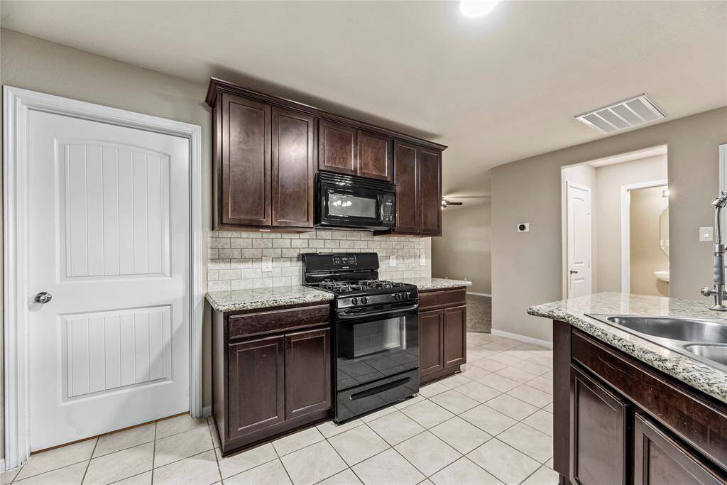 Your kitchen space flows seamlessly on easy care tile flooring.