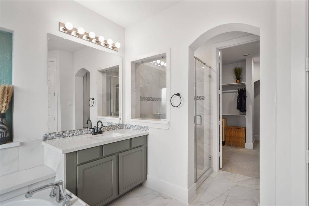 Separate walk-in shower with sleek tile surround and upgraded glass door—offering convenience and elegance.