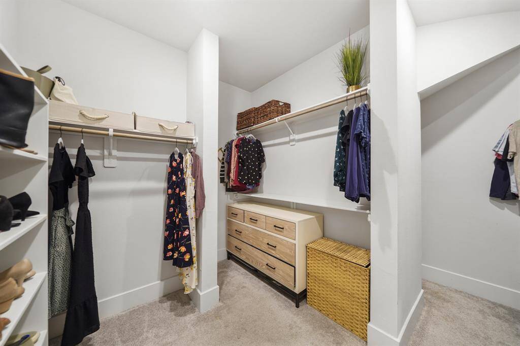 Large walk-in closet with built-in shelving and storage.
