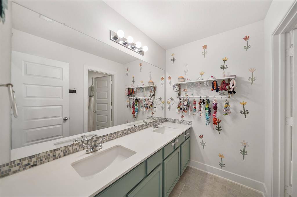 Upstairs full bathroom with double sinks and a spacious layout—perfect for busy mornings or shared use.