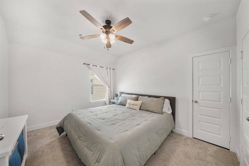 Additional bedroom with bright natural light and neutral tones, offering flexibility for a nursery or guest suite.