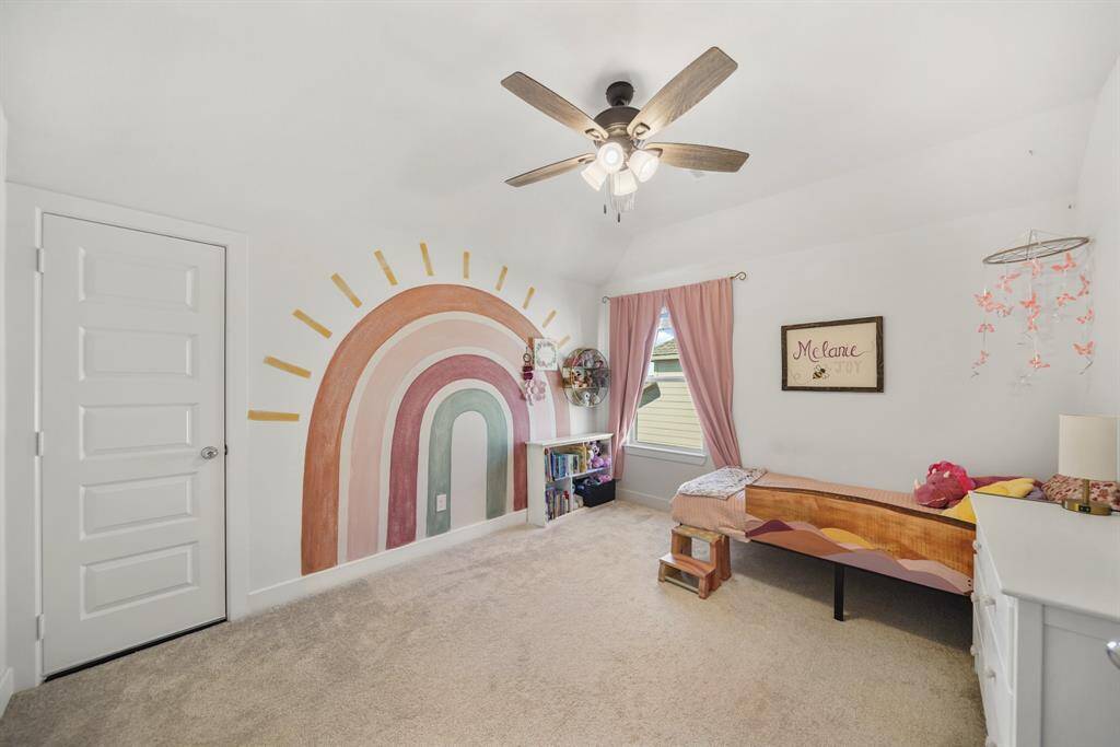 Upstairs secondary bedroom with large windows, plush carpet, and ample closet space.