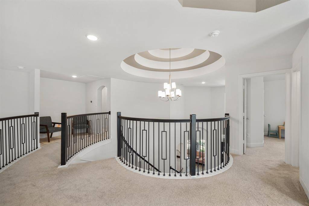 Rotunda ceiling detail with upgraded lighting and graceful lines, adding a custom-home feel to this thoughtfully designed layout.