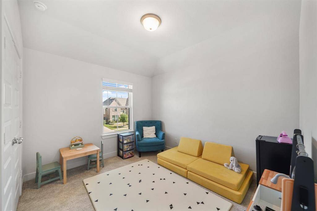 Upstairs secondary bedroom with large windows, plush carpet, and ample closet space—ideal for kids, guests, or a home office.