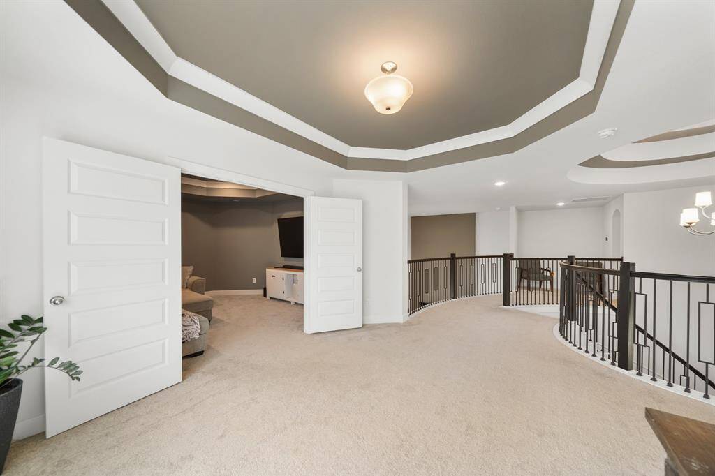 Open and airy game room located upstairs, perfect for family game nights, a pool table, or creating the ultimate kids’ play zone.