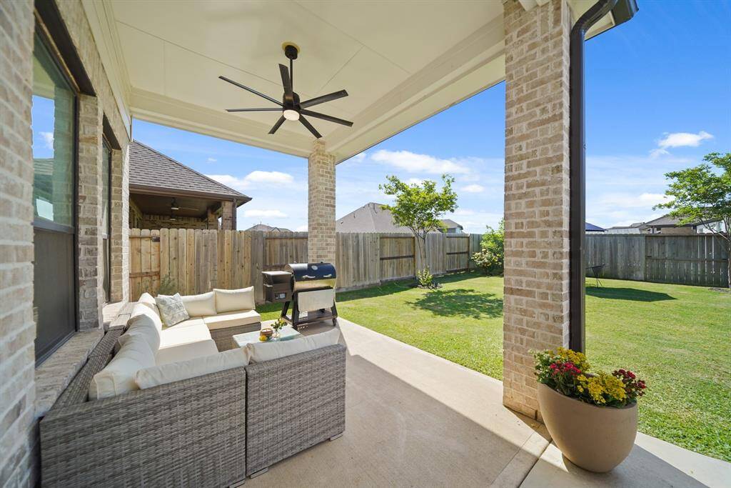 View of the covered patio with space for outdoor dining, lounging, and even a future kitchen.