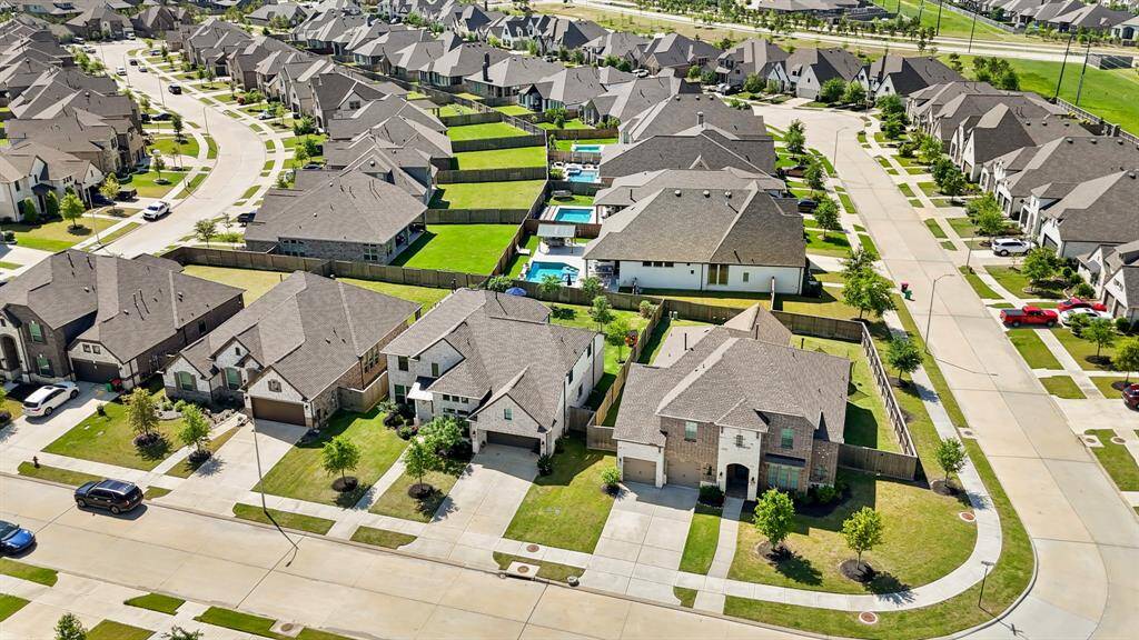 Aerial view showcasing the stunning two-story home with brick and stone elevation.
