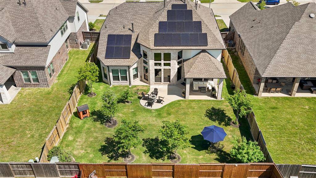 Expansive backyard with mature trees providing natural shade, privacy, and a peaceful atmosphere.