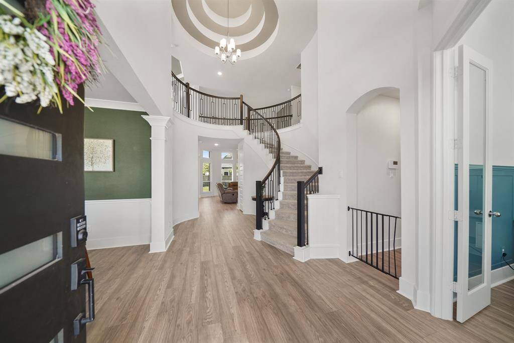 Foyer leading into open living spaces with upgraded lighting.