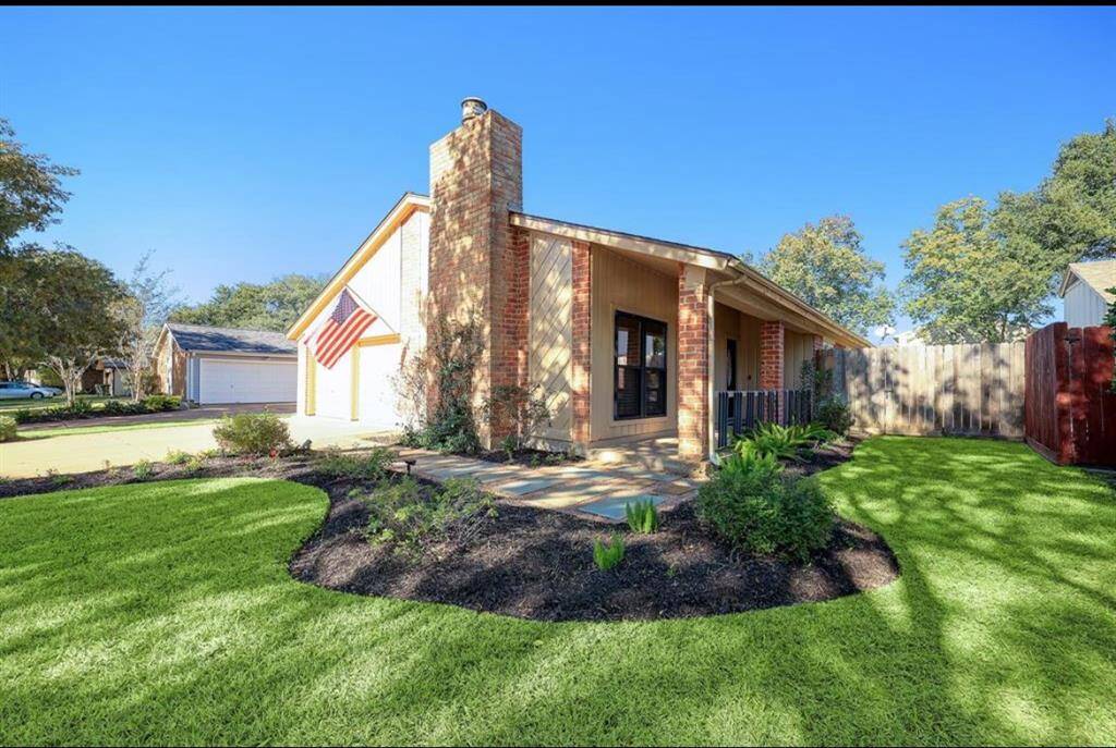 Fully furnished home with side porch that leads to the front door.