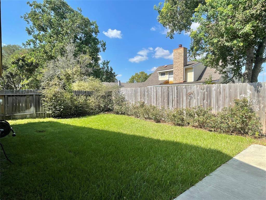 Well maintained backyard with landscaping and sprinkle system