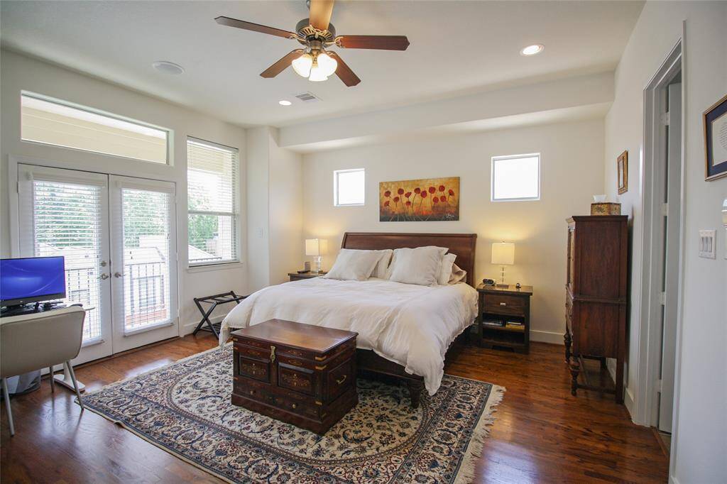 Welcome to your primary suite! Hardwood floors extend throughout the entire 3rd floor! You will truly enjoy the private covered balcony, natural light, & the vast space of this master bedroom!
