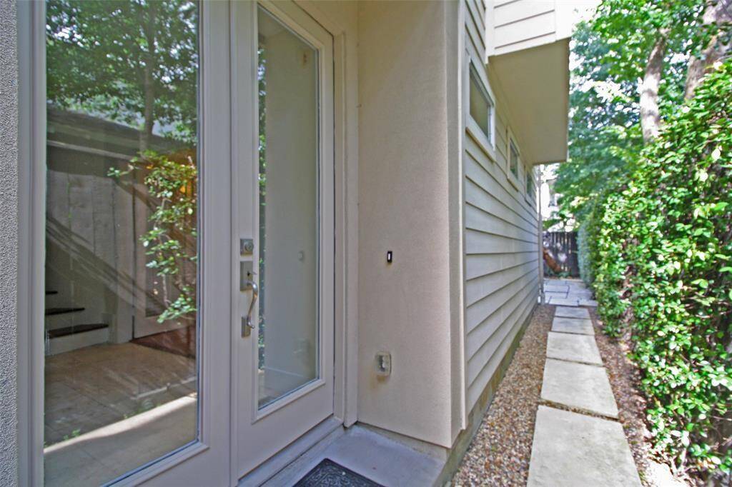 Gated front Entry leads to Modern Glass French Doors and Backyard.