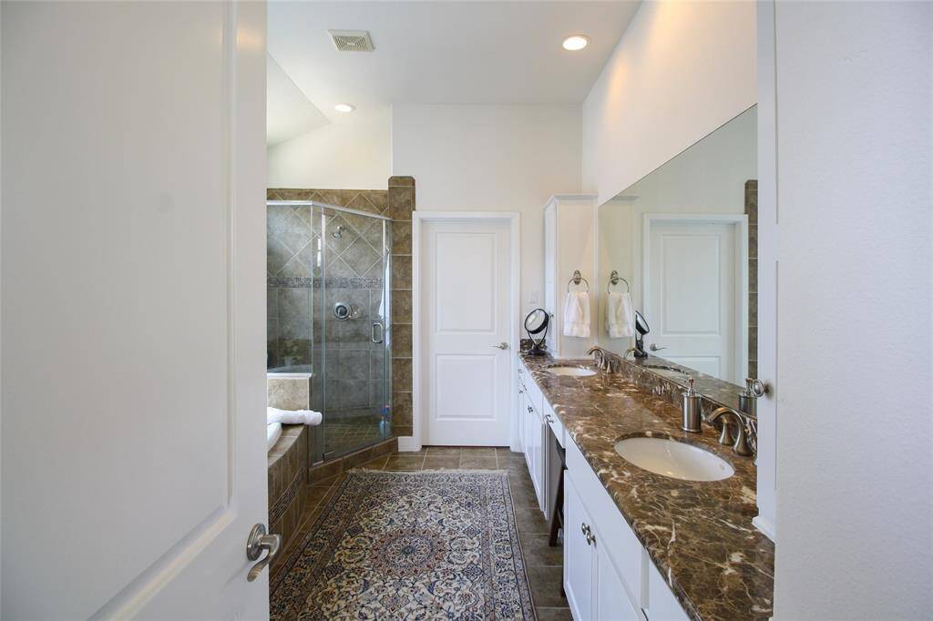 A luxurious primary bathroom. Look at all the counter space!!! Plus separate cabinets for each sink!