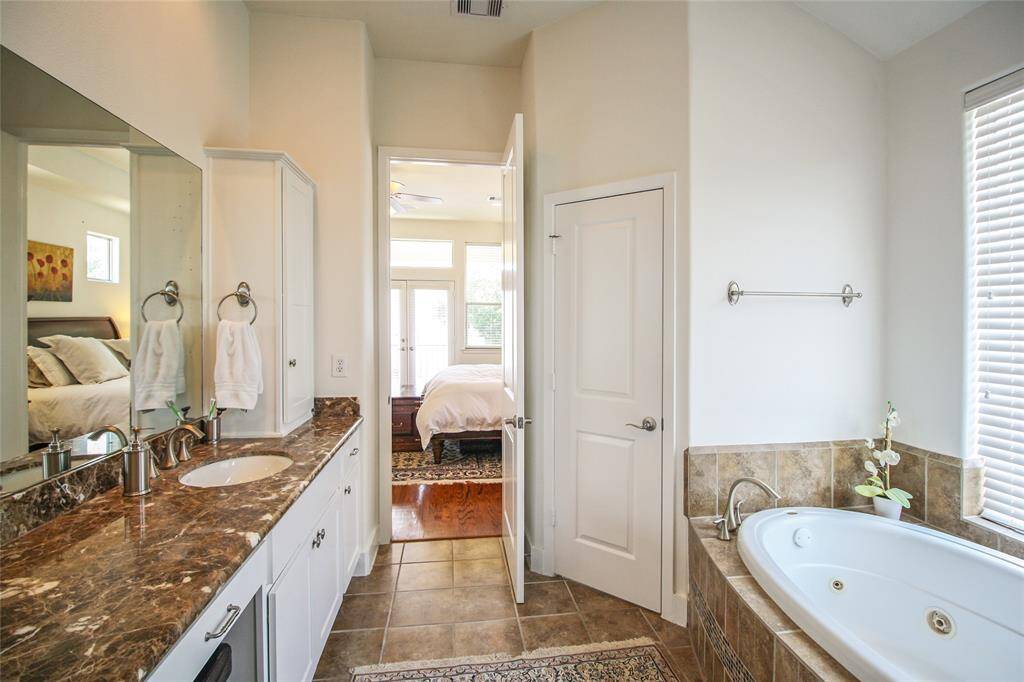 The perfect primary suite. Spacious with warm natural light for relaxing in the jacuzzi tub.