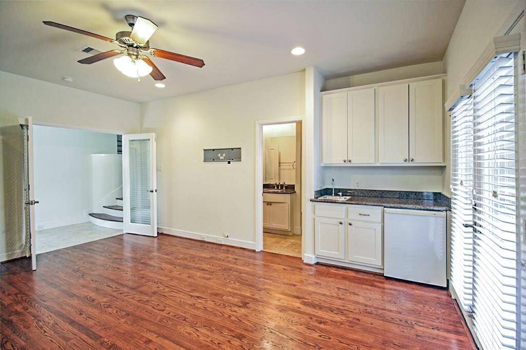This room is HUGE for a first floor bedroom! The photo does not show how great of a size this room is! It’s perfect as a secondary suite or game room. Mini fridge, wetbar, & builtins! The dual glass French doors lead to the covered back patio area and to the large back yard/patio.