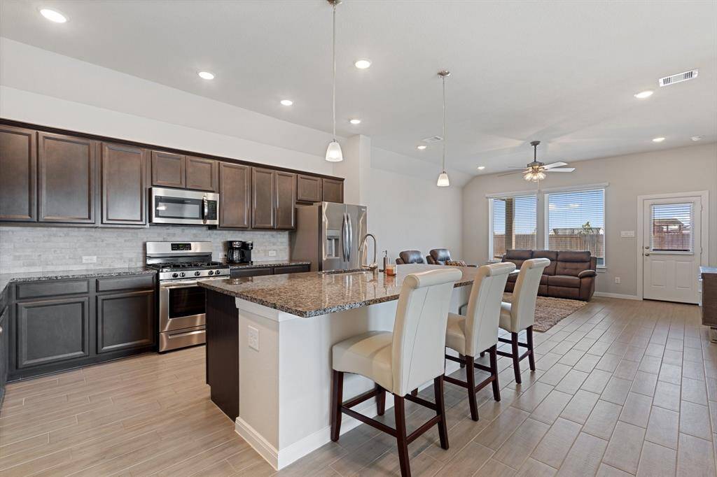 Next you will enter the main living area. This open concept with the kitchen and family room allows for ease of entertaining in a large space.