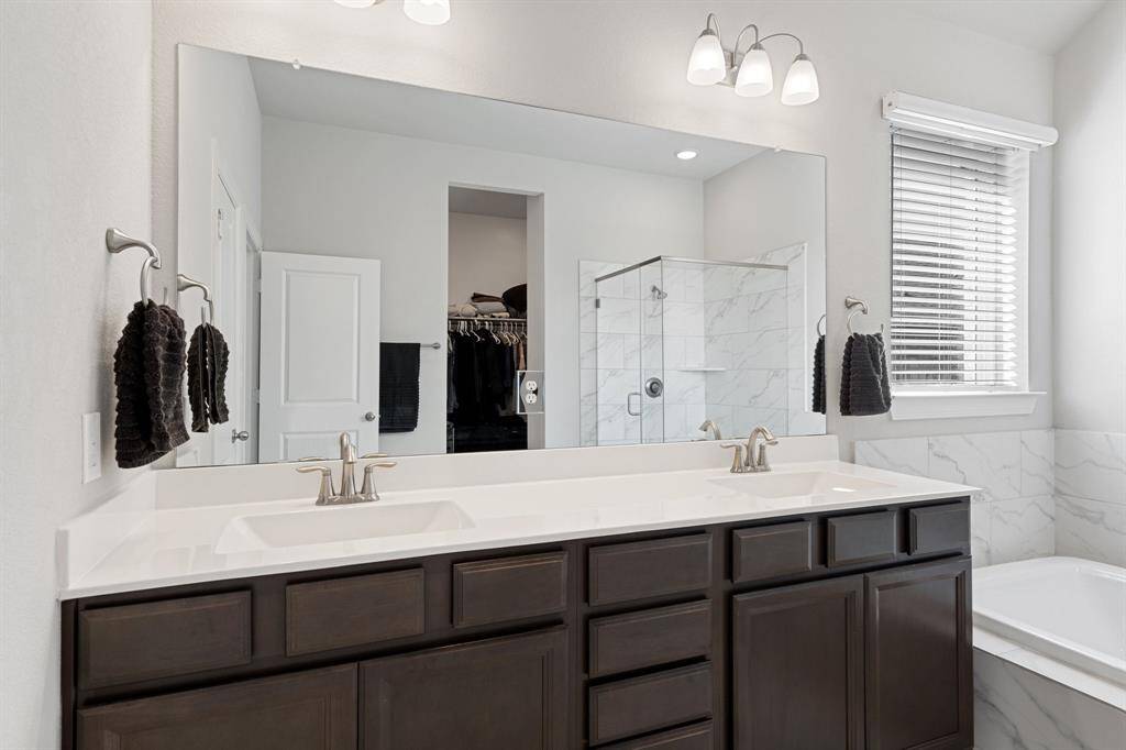 Primary bathroom is complete with dual sinks, oversized shower and separate tub.