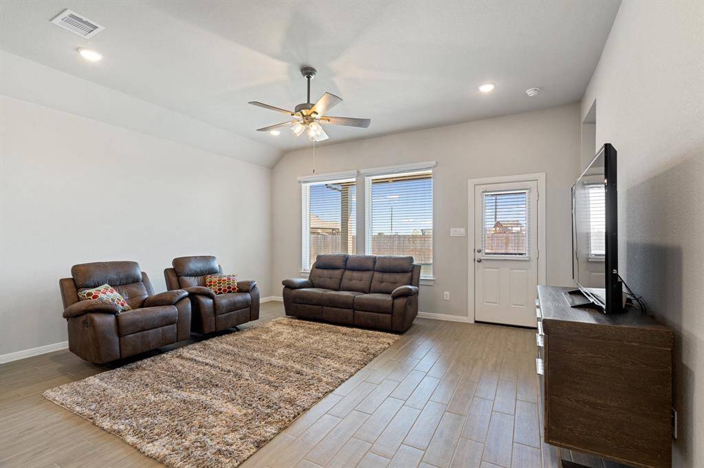 Family room is open to the kitchen area in the back of the home.