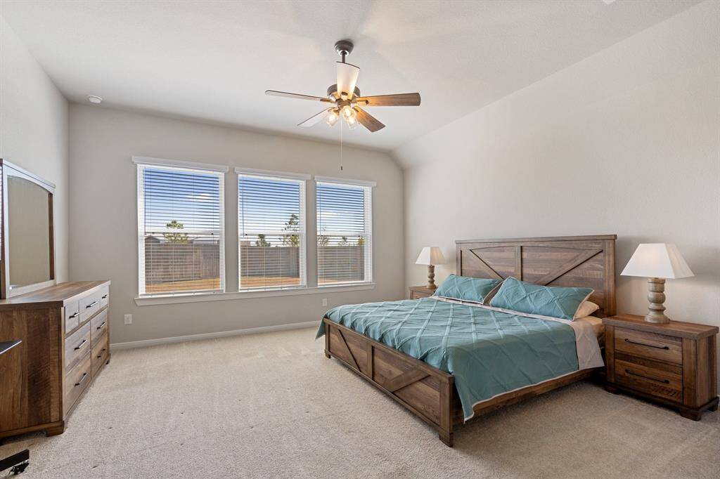 Large Primary bedroom has three large windows to allow plenty of natural light into the room.