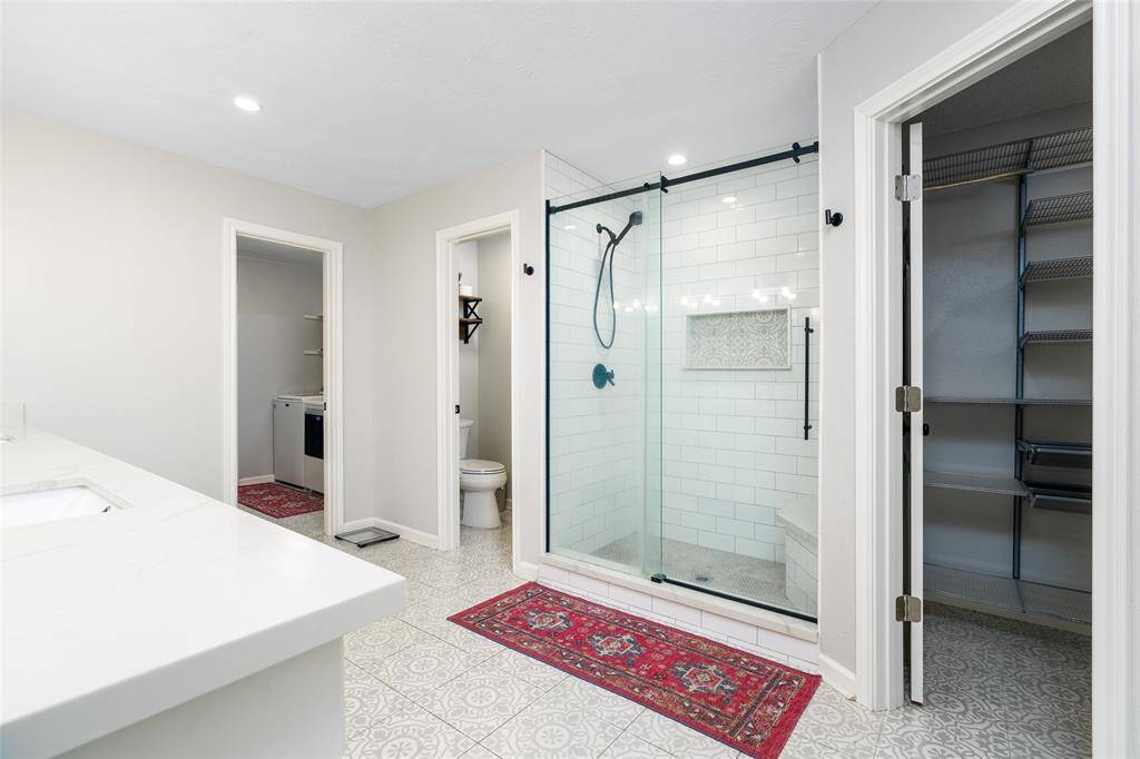 Primary bath with vanity area, lots of built in cabinets.