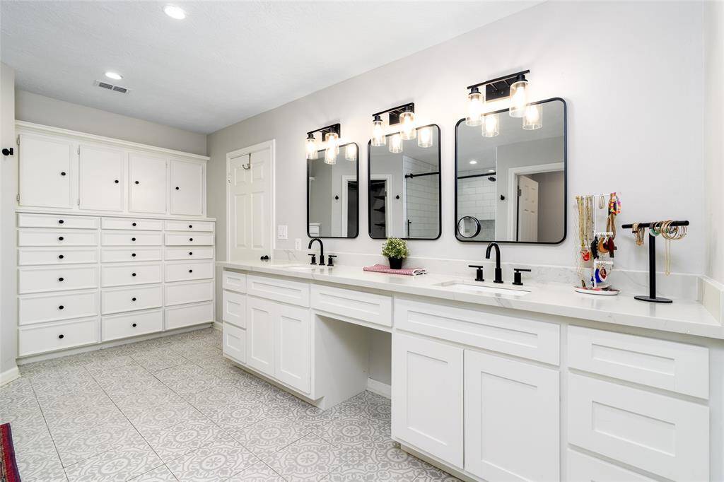 Primary bath with vanity area, lots of built in cabinets.