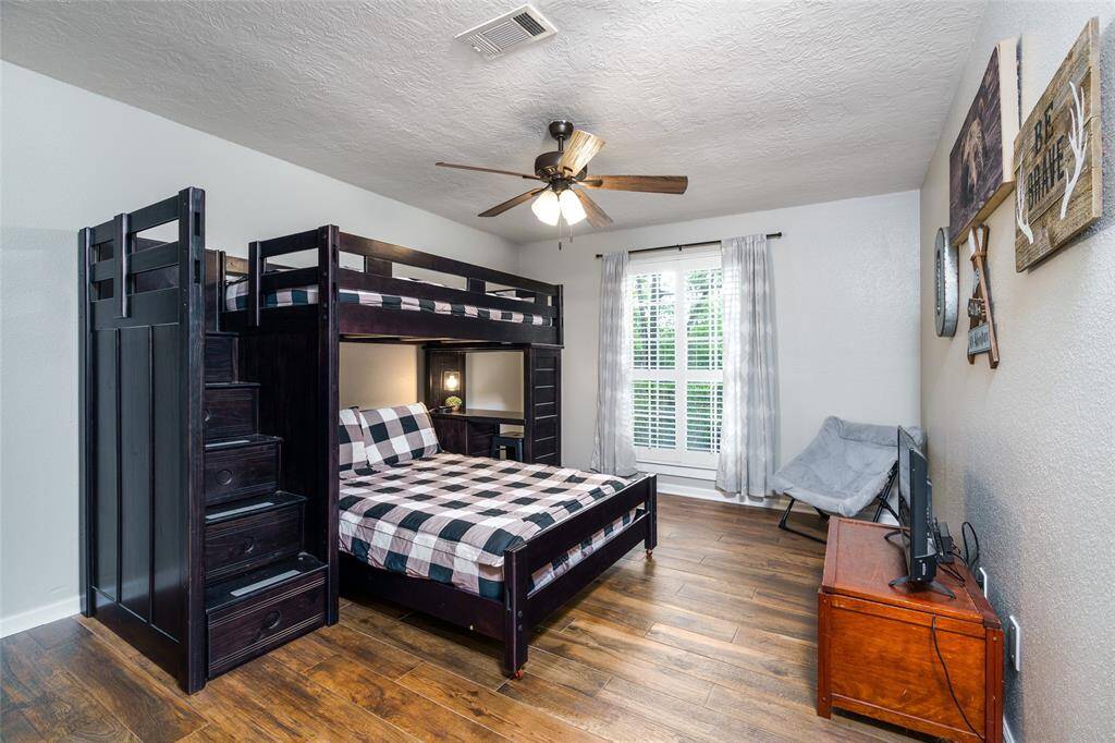 Second bedroom with tile flooring and walk in closet.
